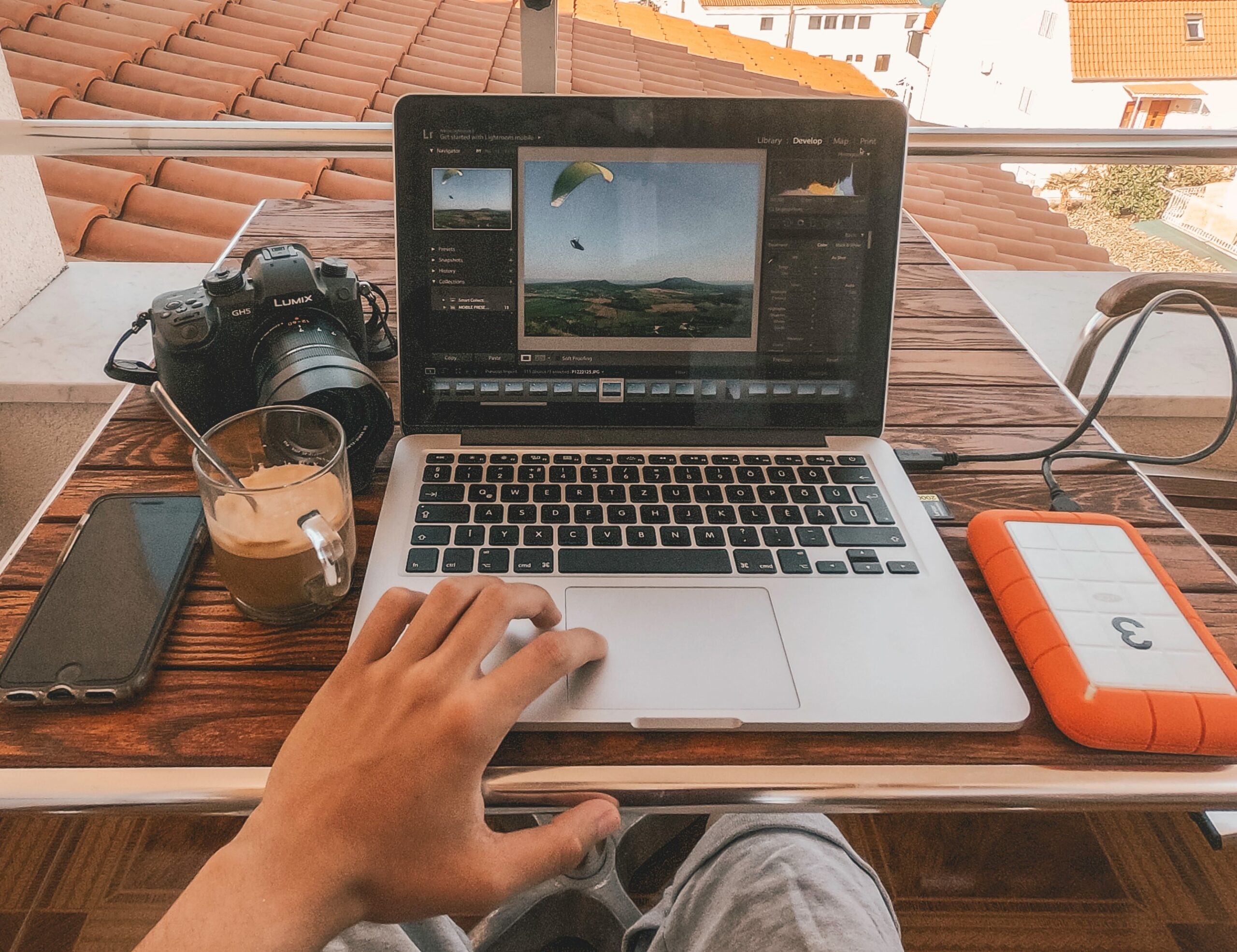 laptop and camera sitting on a desk
